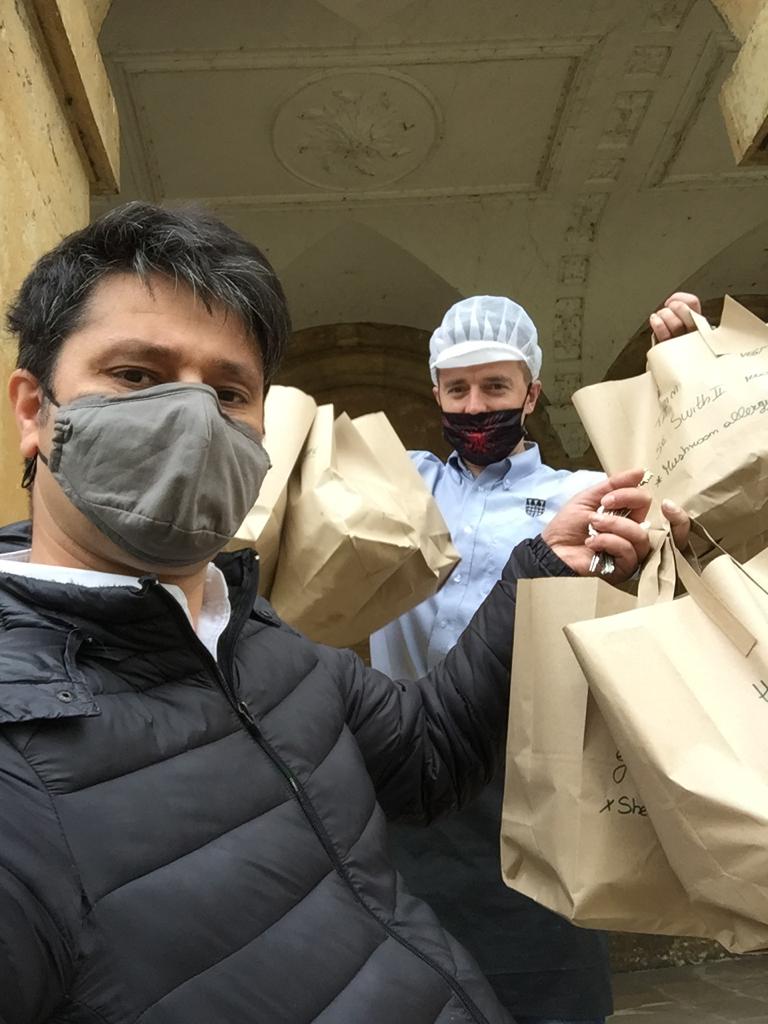 Colour photograph of Salar Kashani and Mirek Krukowski delivering meals to students in quarantine in the New Building during the covid-19 pandemic.