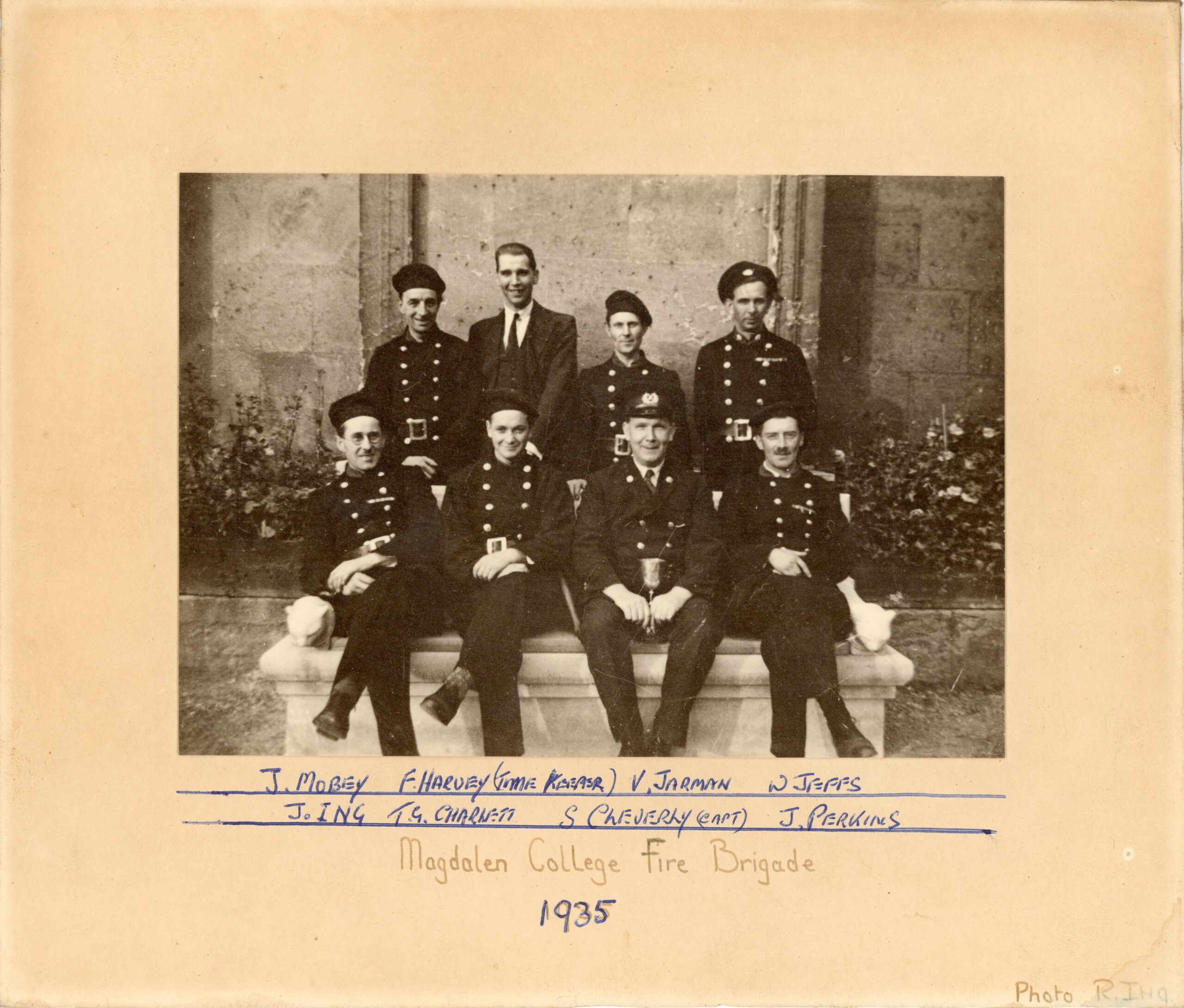 Black-and-white formal photograph of Magdalen College Fire Brigade, 1935. There are eight sitters.