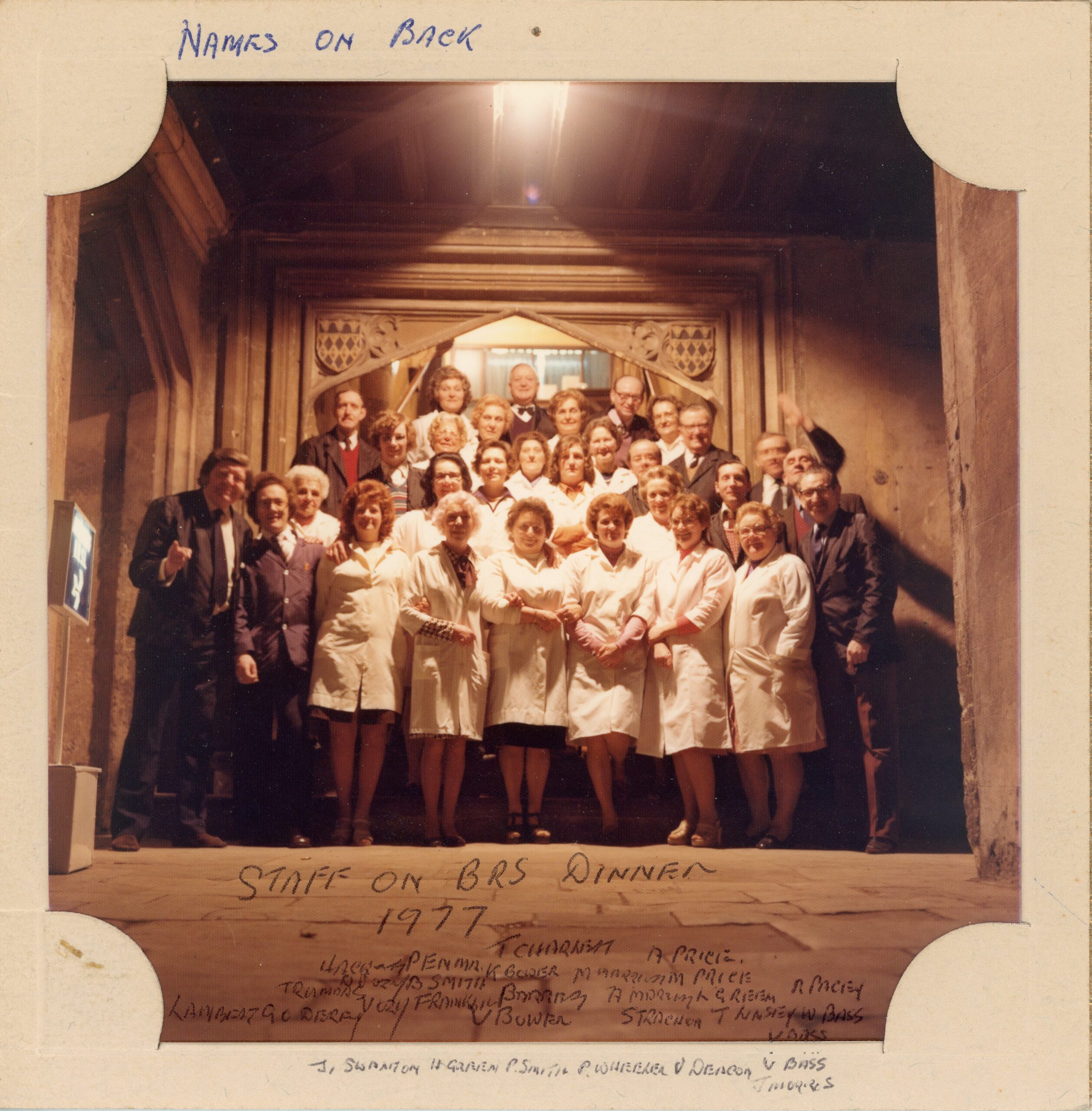Colour photograph of Magdalen College buttery staff posing on the Hall steps during a dinner held in 1977 for the British Road Services (BRS).
