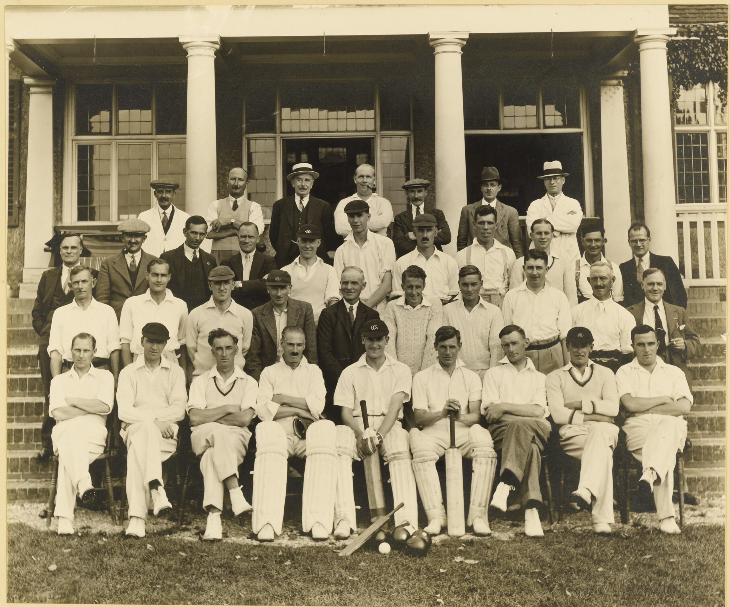 Black-and-white Magdalen College Servants Sports Club photograph, posed outside the Magdalen sports pavilion, 1935.