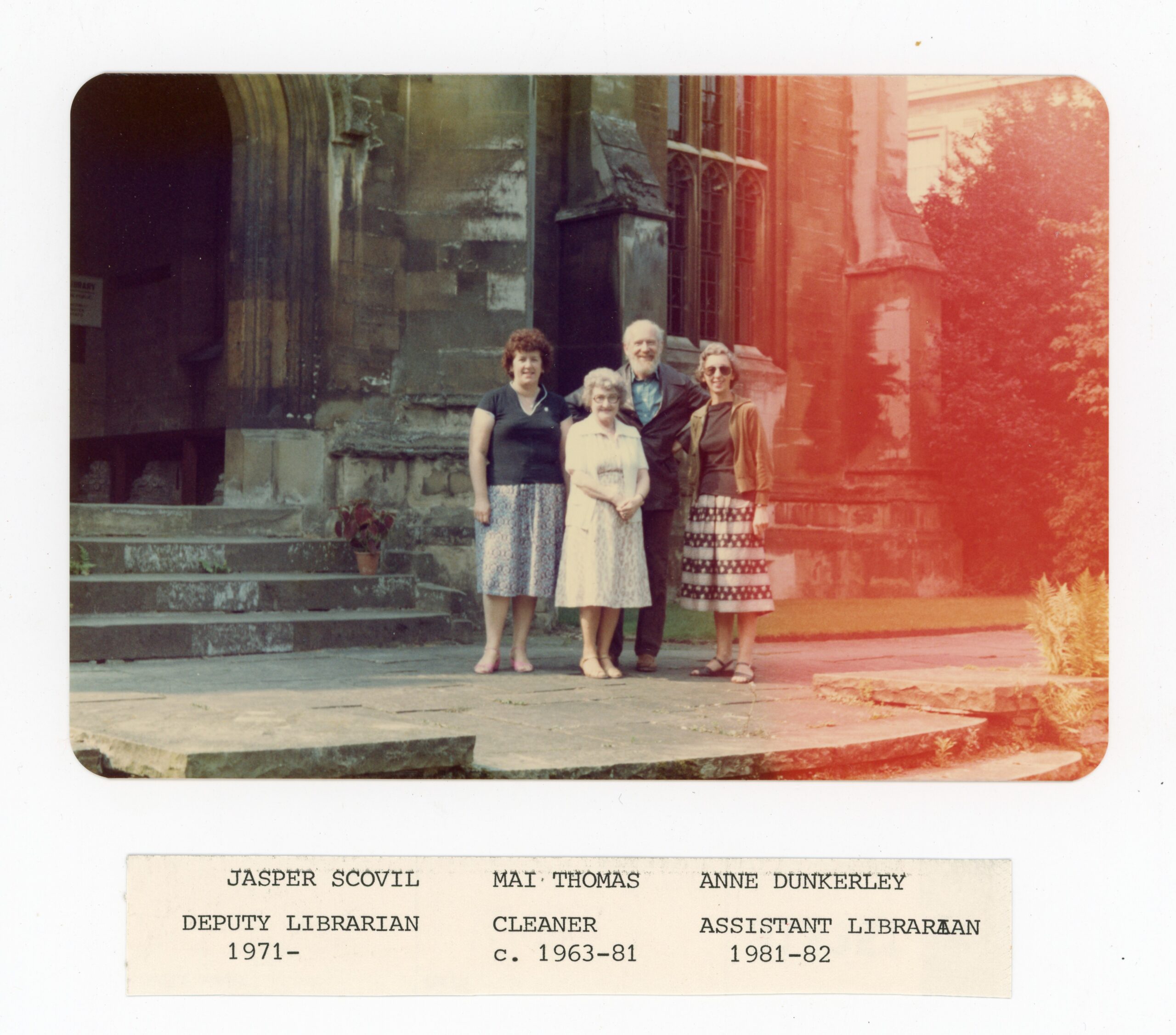 Colour photographs of four individuals posed outside Magdalen's New Library (now known as the Longwall Library), circa 1982, of who, three are identified: Jasper Scovill, Deputy Librarian; Mai Thomas, cleaner from 1963-1981; and Anne Dunkerley, Assistant Librarian from 1981-1982.